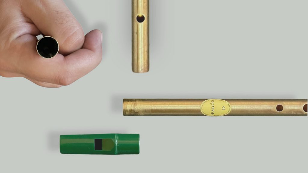 Close-up views of the Feadog brass tin whistle bottom end and tuning slide