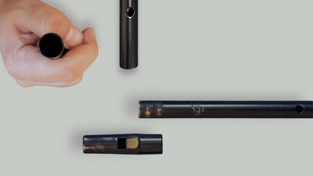 Close-up views of the Shush PRO tin whistle bottom end and tuning slide